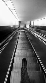 Low section of man on escalator