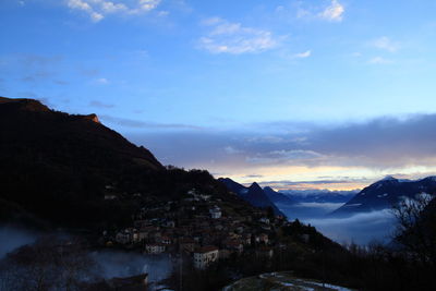 Mountain range and townscape ensconced in fog