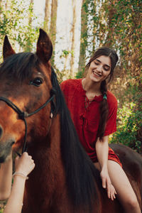 Young woman smiling while looking away outdoors