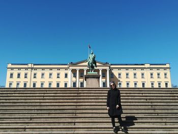 Low angle view of statue against clear blue sky