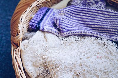 Close-up of warm clothing in wicker basket