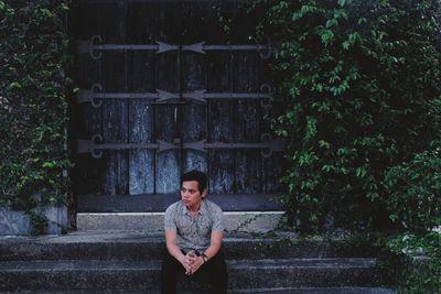 Full length of girl standing against trees