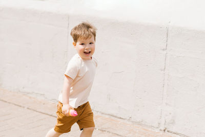 Blur cute caucasian boy of three emotionally runs through the park in the summer person