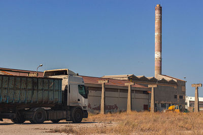 View of factory against clear blue sky