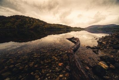 Scenic view of lake against cloudy sky