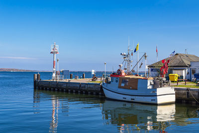 Boats moored at harbor