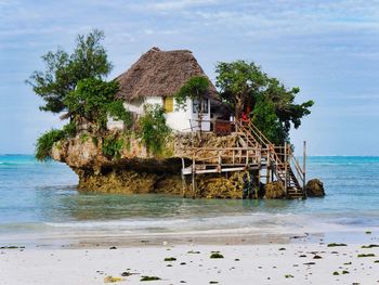 House by sea against sky