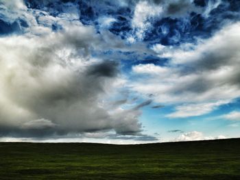 Scenic view of landscape against cloudy sky