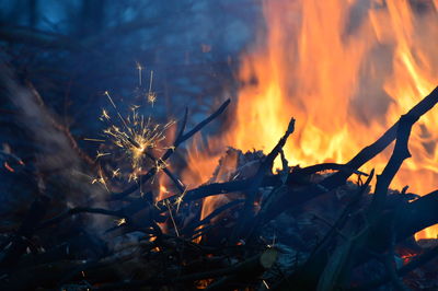 Close-up of bonfire against orange sky