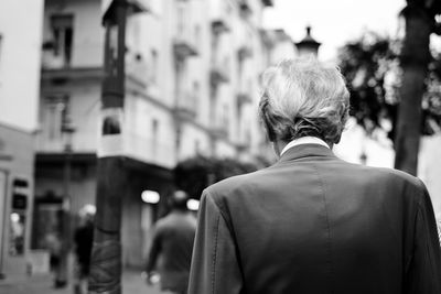 Rear view of man walking on street