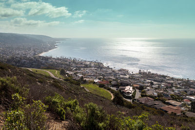 Scenic view of sea by city against sky