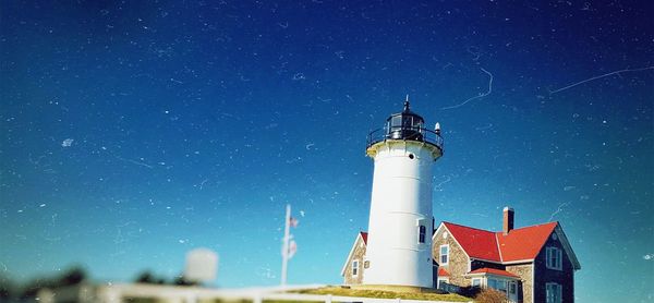 Low angle view of lighthouse against blue sky