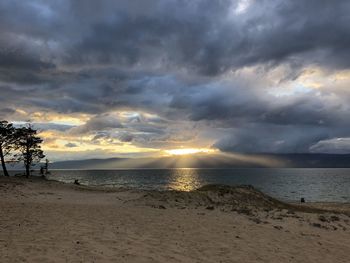 Scenic view of beach against sky during sunset