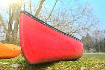 Close-up of red boat on land