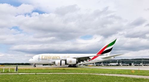 Airplane on runway against sky