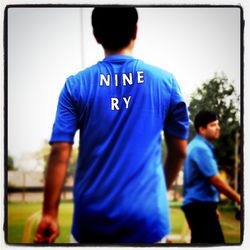 Rear view of woman standing in park
