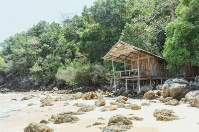 Built structure on rocks by trees in forest