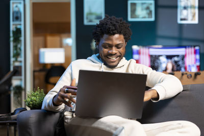 Man using laptop while sitting at home