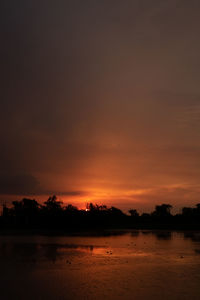 Scenic view of lake against romantic sky at sunset