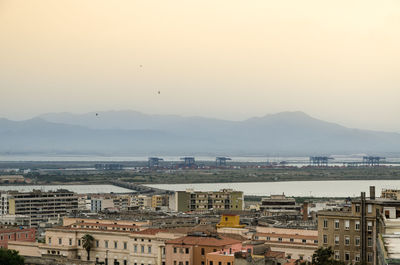 High angle view of townscape by sea against sky