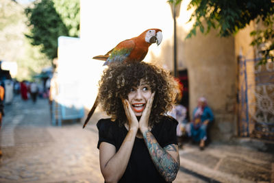 Portrait of smiling young woman in city