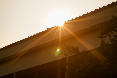 Low angle view of sunlight streaming through building