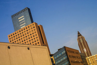 Low angle view of skyscrapers against clear sky