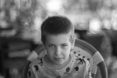 Portrait of cute boy sitting outdoors