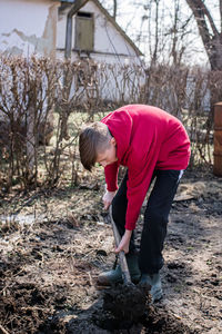 Side view of man working on field