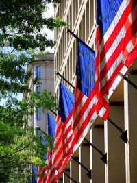 Low angle view of flag against built structure