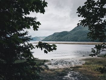 Scenic view of lake and mountains against sky