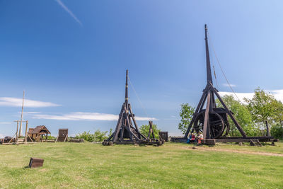 Traditional windmill on field against sky