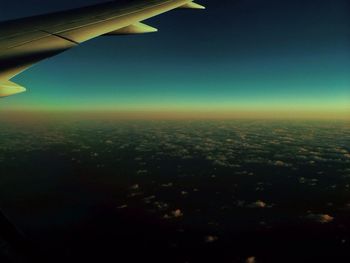 Cropped image of airplane flying over landscape