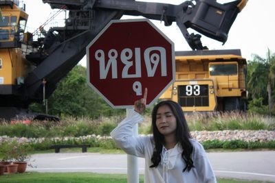 Portrait of young woman with arrow sign