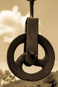 Close-up of metal structure against sky