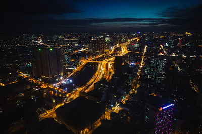 High angle view of illuminated buildings in city at night