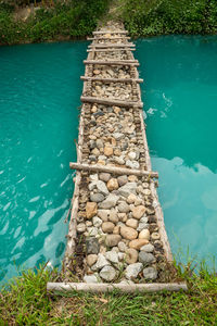 High angle view of stone stack on rock by lake