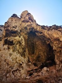 Low angle view of rock formations against sky