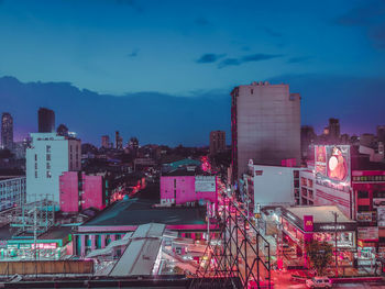 High angle view of illuminated buildings against sky at dusk