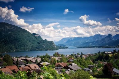 Scenic view of townscape by sea against sky