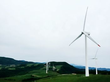 Wind turbines on grassy field