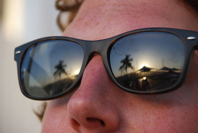 Close-up of man wearing sunglasses with reflection