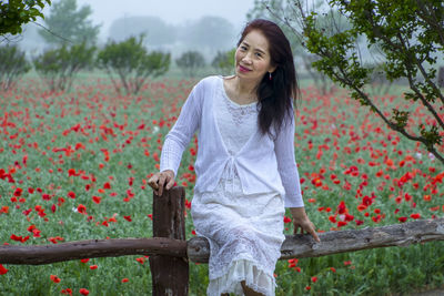 Portrait of smiling young woman standing outdoors