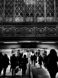 Rear view of people walking in subway