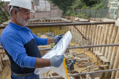 Side view of man working at construction site