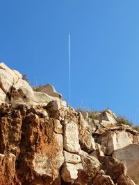 Low angle view of desert against clear sky