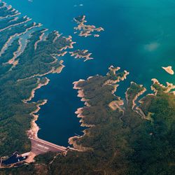 High angle view of tree by mountain against sky