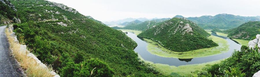 High angle view of river amidst mountains against sky