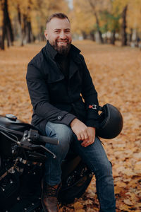 Portrait of young man sitting outdoors