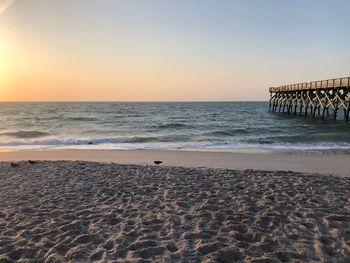 Scenic view of sea against clear sky during sunset